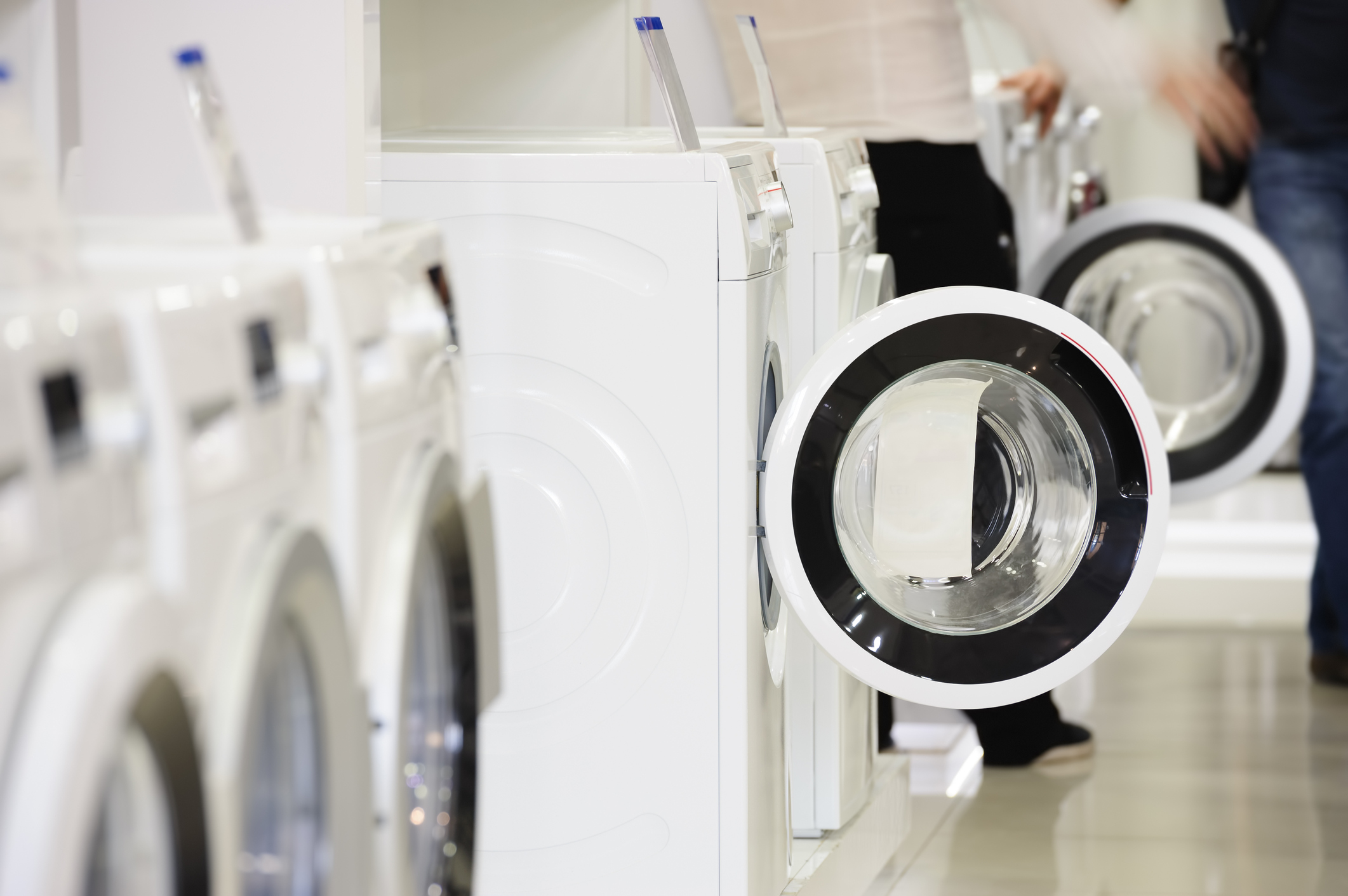 washing machines in appliance store and defocused buyer